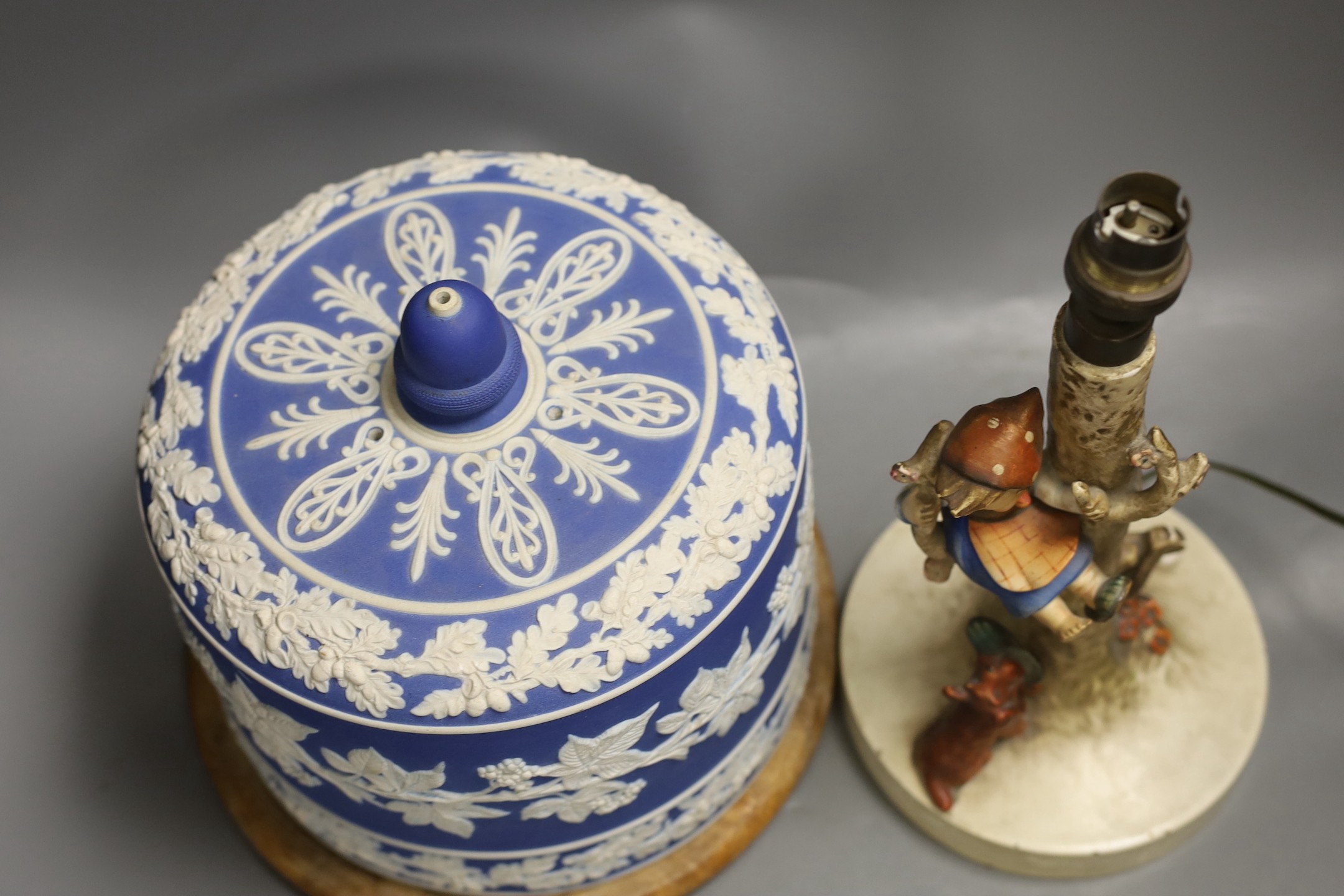 A Victorian blue jasper cheese bell cover, later wood stand, 23 cm high, and a Hummel table lamp